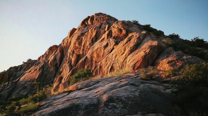 Fototapeta premium Majestic Sunset Hues on Rugged Mountain Rock Face
