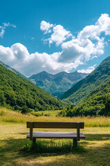 Wooden Bench Overlooking a Verdant Valley and Rugged Mountain Range Under a Clear Blue Sky, Representing Peace, Relaxation, and a Connection to Nature