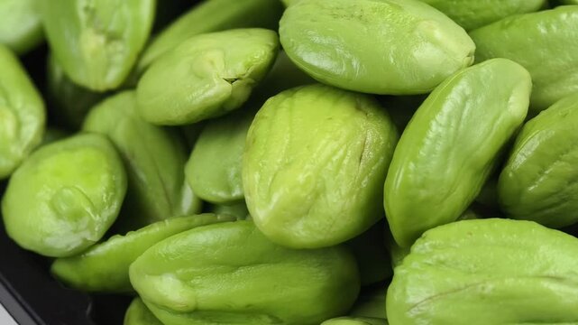 Fresh stink beans rotating on a plate