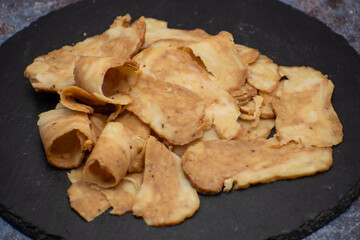 Seitan: vegan meat alternative made with vital wheat gluten, sliced on slate board