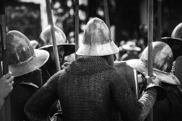 Black and White Silhouettes of Knights in Metal Armor with Medieval Weapons