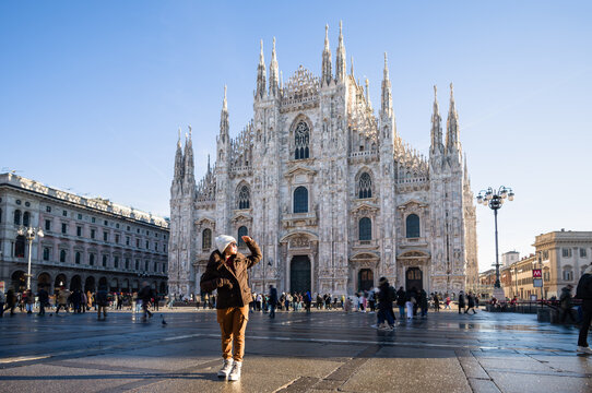 Asian woman in front of the Duomo, Milan, Italy