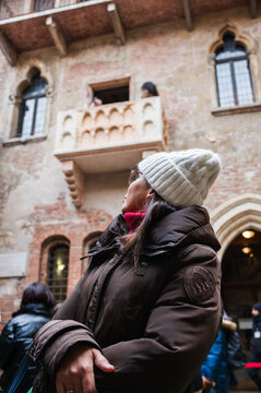Asian woman looking at Juliet's balcony, Verona, Veneto, Italy