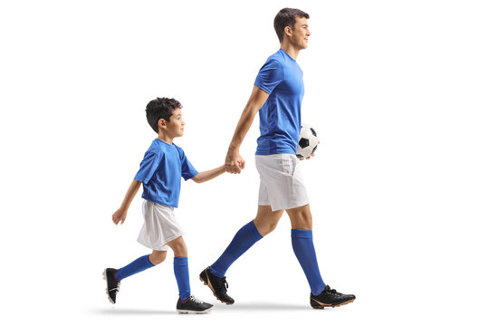 Full length shot of a football player walking and holding hand with a little boy