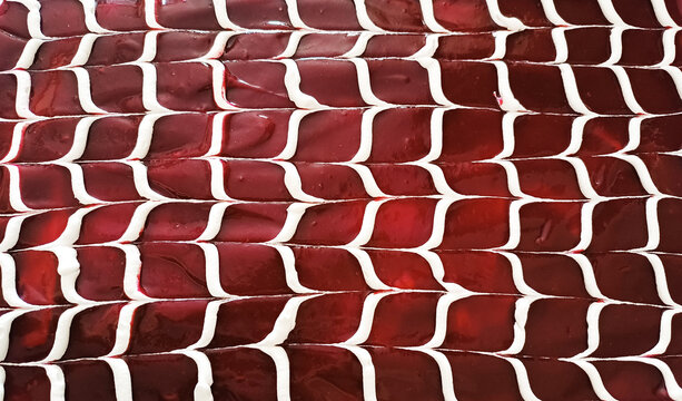 trilece on the wooden background.Dessert muhallebi pudding with jelly raspberry.Close up