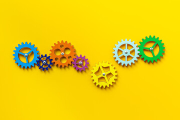 Colorful gears are connected together as a symbol of teamwork and business automation