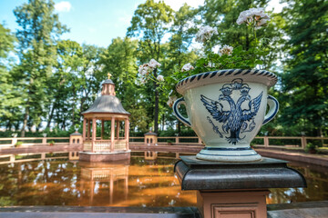A pond with a gazebo in the summer garden of St. Petersburg in Russia.