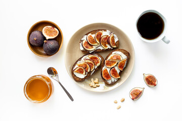 Breakfast with figs and cheese toasts with honey, top view