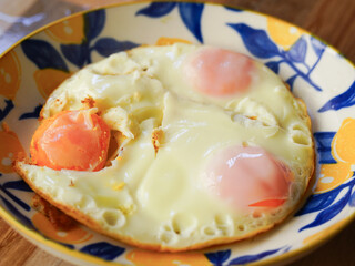 Fried eggs on a plate on a wooden table. Close-up