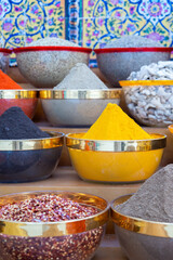Traditional spices market. Pots and wooden tubs stand in row with colorful tea, spices, fruits, roots, flowers. Street bazaar.