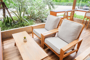 Wooden chair and wooden table in restaurant,Rattan chair in scandinavian interior of living room,Mediterranean minimal wall and green plant exterior architecturer,warm beige tones,copy space.