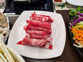Shabu Shabu. Thinly sliced ​​beef on a plate