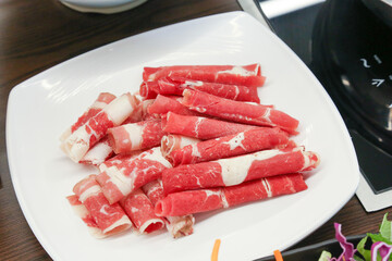Shabu Shabu. Thinly sliced ​​beef on a plate