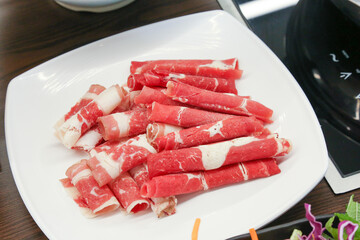 Shabu Shabu. Thinly sliced ​​beef on a plate