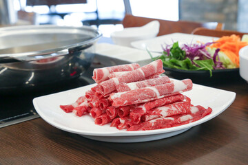 Shabu Shabu. Thinly sliced ​​beef on a plate