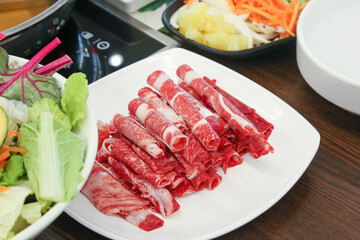 Shabu Shabu. Thinly sliced ​​beef on a plate