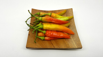 Fresh cayenne pepper picked from the garden ready to be made into food, on a white background