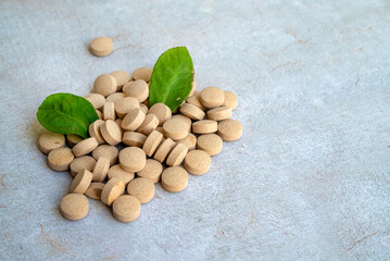 Herbal Supplements and green leaves . Herbal Remedies  Tablets  