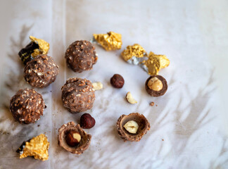 Chocolate candy with hazelnut on shadows  background.