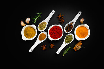 Various herbs and spices on dark background. Concept composition top view