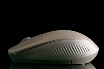 One wireless computer mouse, macro, isolated on a black background.