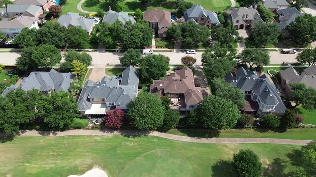 Luxury residential mansion houses concrete tiles roof, swimming pool along club car concrete pathway at upscale golf course community in East of Plano, Texas, Dallas Fort Worth metroplex, flyover