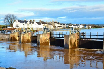 A flood barrier system protecting a coastal city, with gates closed to prevent seawater from flooding streets