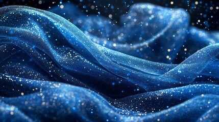 Obraz premium Glittering blue fabric waves, dark background, bokeh