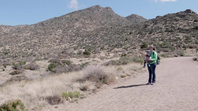 Mother Hiking with Baby Boy In Albuquerque Foothills