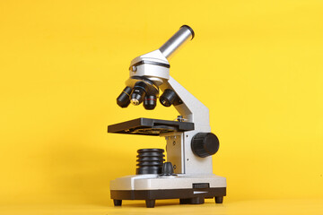 A microscope on a yellow background