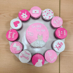 Pink bridal shower cake and cupcakes.
