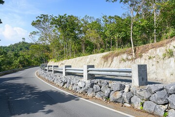 Fototapeta premium A landslide prevention barrier along a mountain road, with sturdy barriers installed to protect against rockslides