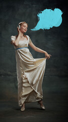 Portrait of elegant beautiful young woman in silk dress, royal person listening to music in headphones with blue speech bubble against dark vintage green background. Creativity, relaxation, dreams