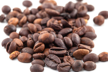 Coffee beans isolated on white background. A heap of coffee beans stacked together, ready to be brewed into a delicious cup of coffee.