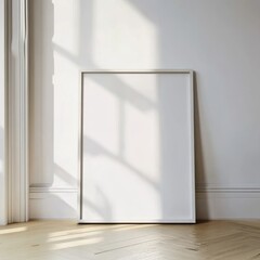 A wooden frame with a white background is leaning against a wall, casting shadows on a wooden floor
