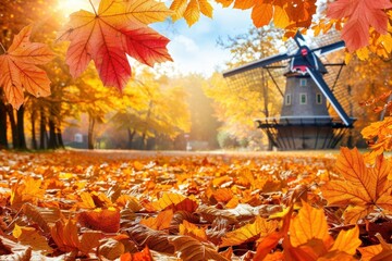 A serene autumn scene featuring vibrant orange leaves scattered on the ground, with a windmill surrounded by colorful trees in soft sunlight.