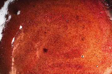 Background with a texture of red brown syrup with bubbles.