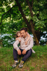 Fototapeta premium A father hugging his daughters, showing love and affection. Ideal for themes related to family, bonding, love, and childhood