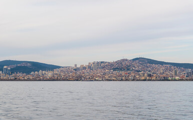 A ferry’s wake trailing through the Bosphorus towards the skyline of Istanbul. The city's modern architecture