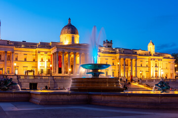 Fountain on Trafalgar square and National Gallery at sunset, London, UK
