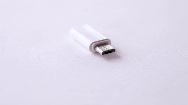 Micro usb connector adapter on a plain surface for device connectivity and data transfer
