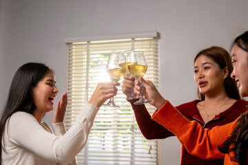 Three women are celebrating with wine glasses