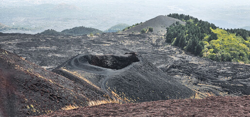 volcanic landscapes of etna with petrified lava flows and desert sand in the summer of 2024