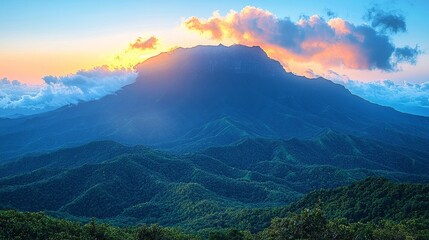 Fototapeta premium Majestic Mountain Ranges Illuminated by Serene Sunset Skies with Cascading Clouds