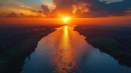Golden Sunset Over a Serene River Landscape Reflecting Warm Hues and Cloud Formations