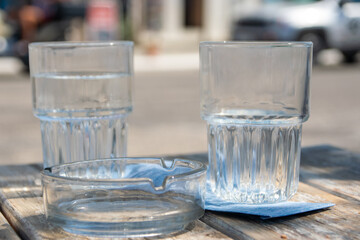 Two Clear Glasses with Water and Ice on Blue Surface