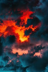 Naklejka premium Vibrant sunset clouds with dramatic orange and blue hues creating a stunning sky backdrop, perfect for nature lovers and landscape photography enthusiasts.