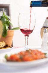 Pouring Red Wine with Italian Cuisine