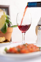 Pouring Red Wine with Italian Cuisine