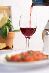 Pouring Red Wine with Italian Cuisine